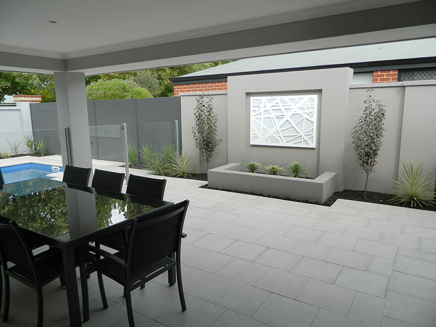 Patio with table and chairs on grey concrete pavers