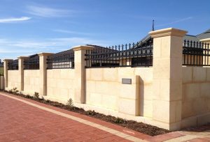 Limestone front yard fence with inbuilt letterbox