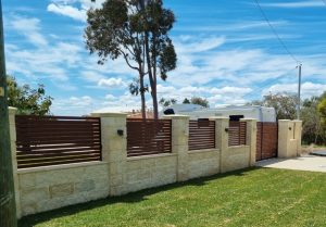 limestone fence pillars with wooden cross beams infront of Perth home