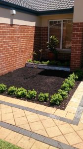 Garden bed surrounded by Rockford Sandstone pavers