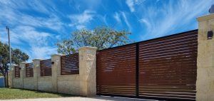 Split face limestone blocks used as pillars for fence